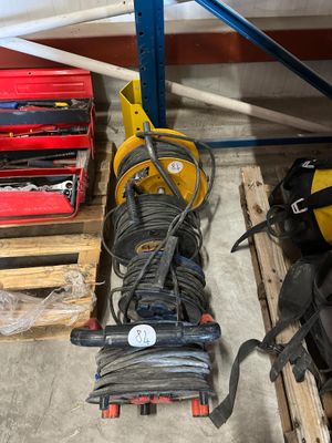 a pile of tools sitting on a pallet in a garage