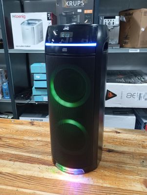 a speaker that is sitting on top of a wooden table