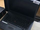 two laptops sitting on a desk next to each other