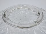 a clear glass bowl on a table with a white background