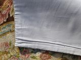 an image of a white pillow on a floral rug