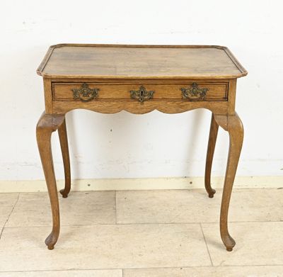 an old wooden table with a drawer on top of it