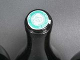 three bottles of wine that are sitting on a table