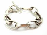 silver bracelet with links and a bar on a white background