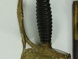 a sword with a gold handle next to a sword with a black handle