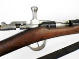 a rifle that is on display on a white surface