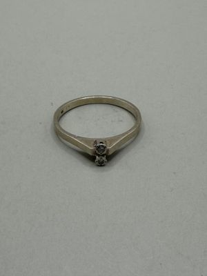a close up of a ring on a table with a white background