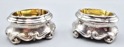 pair of silverplated salt and pepper shakers on a white background