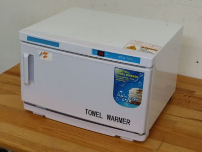 a white microwave sitting on top of a wooden table