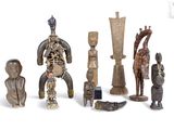 a lot of wooden figurines sitting on a white surface
