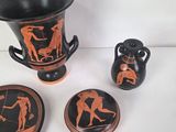 three pieces of pottery that are sitting on a table