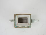 a small white and blue tea pot with a square lid