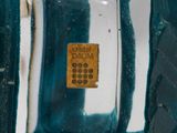 a close up of a glass vase with a cell phone in it