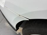 a close up of a white car with a flat tire