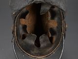 an old black leather hat with a hole in the middle of it