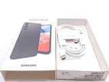 a box with a phone inside of it on a white surface