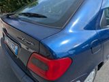 a blue car that is parked on the side of the road
