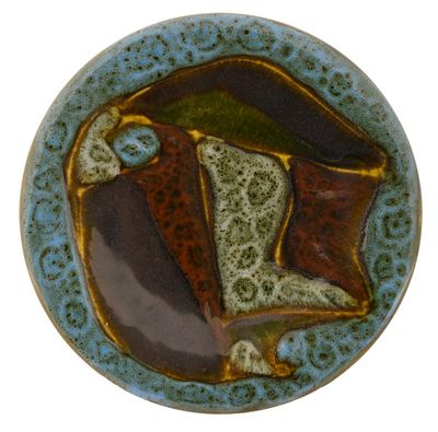 a blue plate with a brown and green design on it