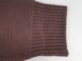 the sweater is brown and has a small hole in the middle of it