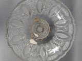 a clear glass plate with a gold plate on it