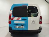 a blue and white van parked in a garage