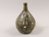 a green vase that is sitting on a white surface