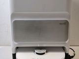a white and black radio sitting on top of a white table