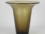 a brown glass vase with a black base on a white background