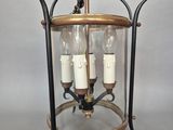 a large lantern hanging from the ceiling with three candles