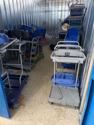 many carts that are sitting in a storage room