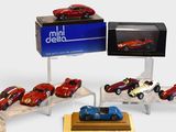 a lot of toy cars that are on display in a display case