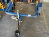 a blue cart with a hose on it in a garage