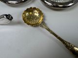 a silver spoon and a silver spoon with a bird on it