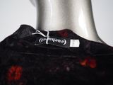 a close up of a black and red tie dye shirt on a mannequin head