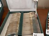 a lot of silverware in a box on a table