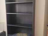 une étagère noire sur laquelle est posé un livre