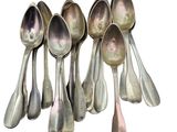 six spoons sitting in a row on a white surface