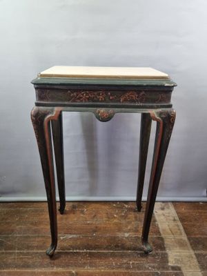 an image of a small table with a marble top on a hard wood floor