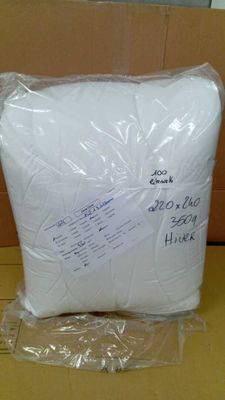 a close up of a pillow in a box on a table