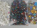 three bags of beads and beads on the table