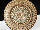 a decorative plate on a white table with a black background