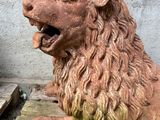 a statue of a lion sitting on top of a wooden box