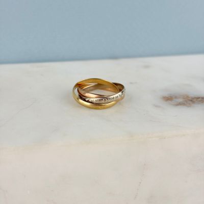 a close up of a gold ring on a marble surface