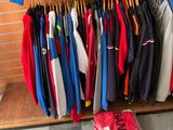 a lot of clothes hanging on a rack in a store