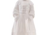 white ceramic figurine of a girl in a dress and hat