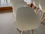 several white chairs are lined up in front of a glass door