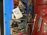 a red pegboard with a bunch of tools on it