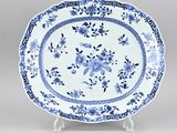 a blue and white plate with a floral design on it