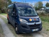 the van is parked on the side of the dirt road
