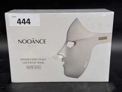 a box with a white mask on it on a table